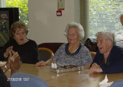 Older women singing happy birthday